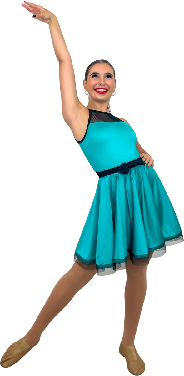 Dancer in a teal dress with one arm raised and a leg extended behind her
